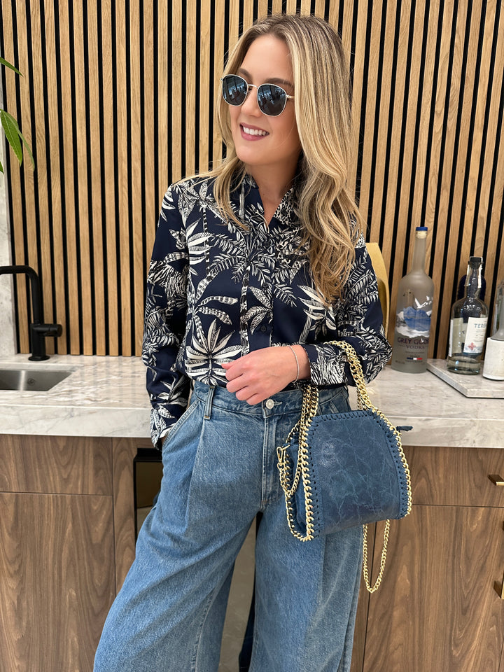 Vilagallo Mafalda Jungle Print Shirt in Navy Blue paired with Agolde Ellis Wide Leg Trousers, BK Metallic Luxe Chain Leather Bag in Denim Blue, Le Specs Neptune Deux Sunnies - all available at Barbara Katz