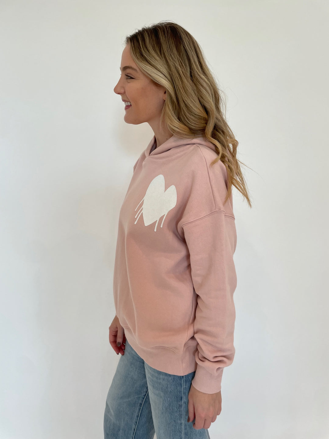 Kerri Rosenthal Unisex Boyfriend Drippy Heart Hoodie in Mauve paired with Pistola Ryder Cuffed Jeans in Essex available at Barbara Katz