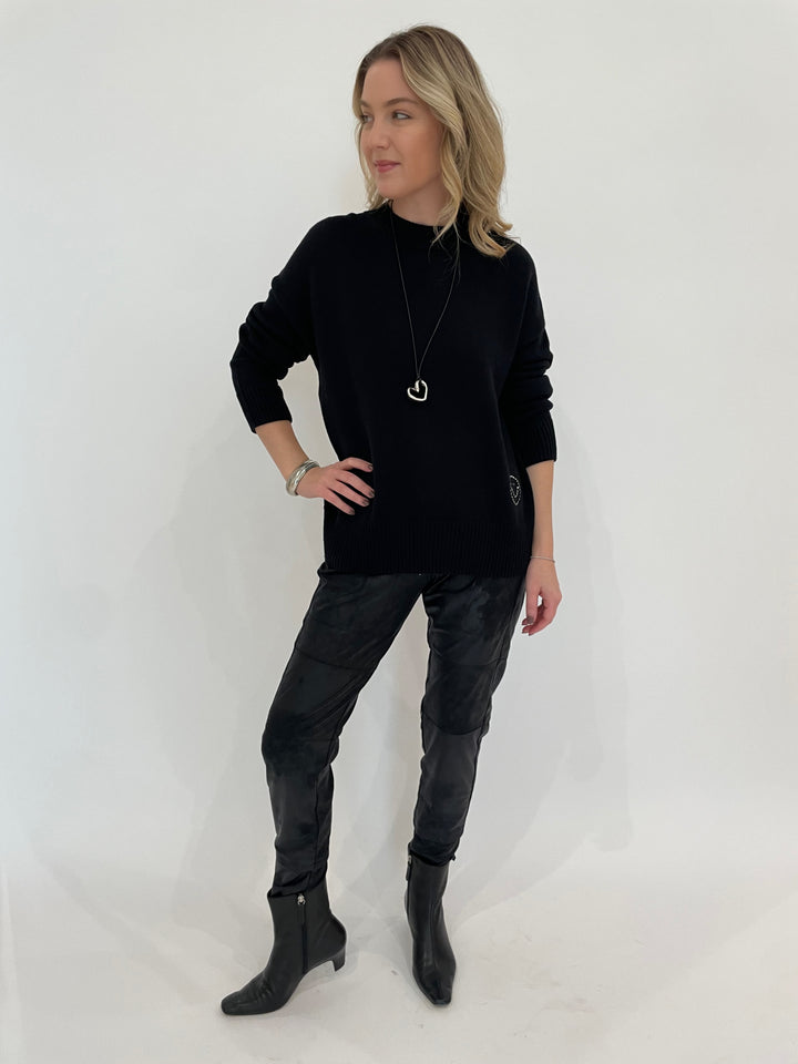 Kerri Rosenthal Benton Last Olive Sweater in Black paired with Raffaello Rossi Candy Vegan Leather Pants in Black, Paula Rosen Jewelry Small Heart Silver With Leather Cord Necklace available at Barbara Katz