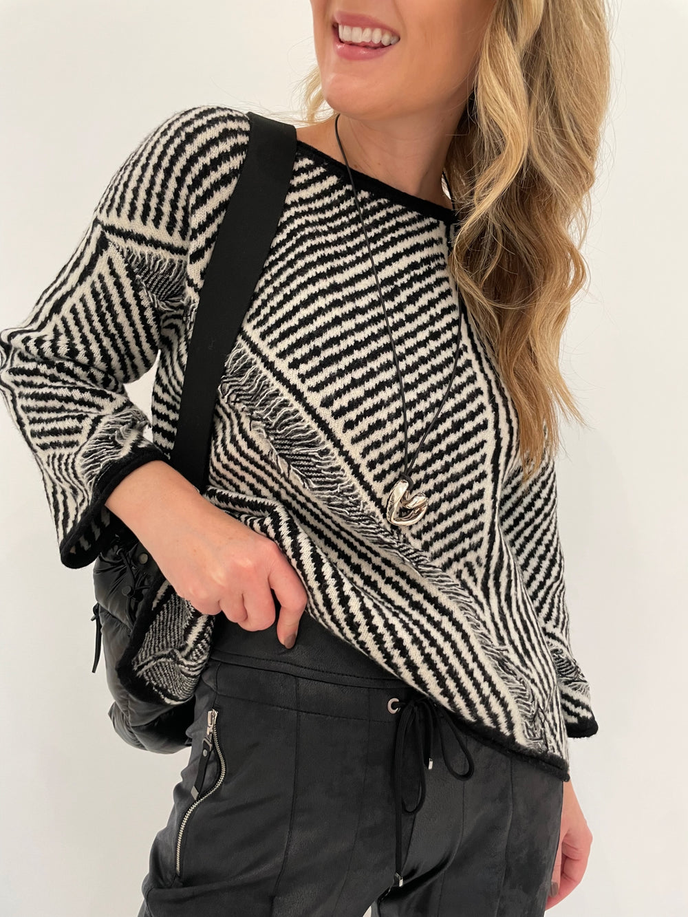 LIV by Habitat Gulia Stripe Fringe Pullover Sweater in Black/White paired with Raffaello Rossi Candy Vegan Leather Pants in Black, Paula Rosen Jewelry Small Heart Silver With Leather Cord Necklace available at Barbara Katz