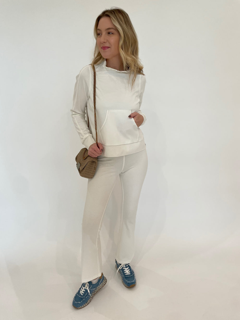 Peace of Cloth Tatum Ruffle Neck Pullover Sweater in Oyster paired with Ella Paramount Knit Pull-On Pants in Oyster, Noam Hazan Mini Milan Bag in Stone available at Barbara Katz