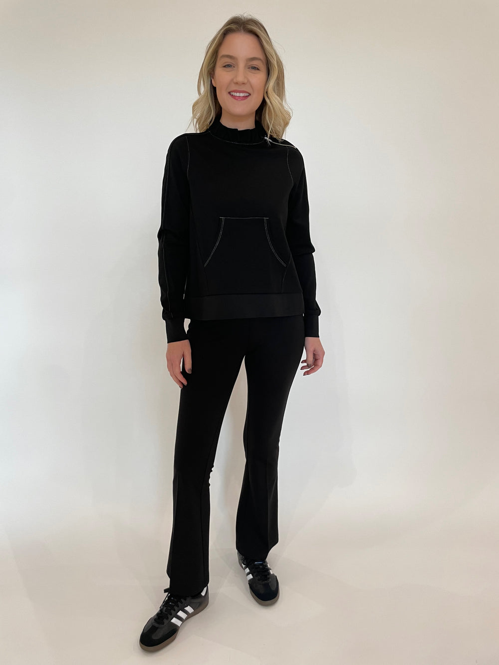 Peace of Cloth Tatum Ruffle Neck Pullover Sweater in Black paired with Ella Paramount Knit Pants in Black available at Barbara Katz