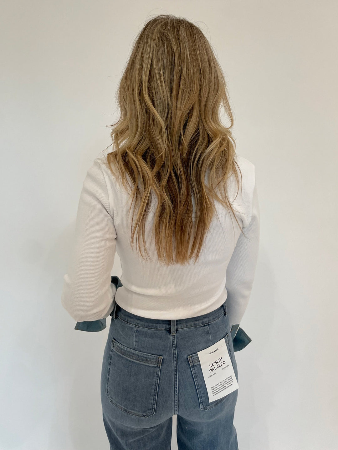 Cinq a Sept Denim Jaden Top in White paired with Frame Le Slim Palazzo Bardot Pocket Jeans in Wilson Clean available at Barbara Katz