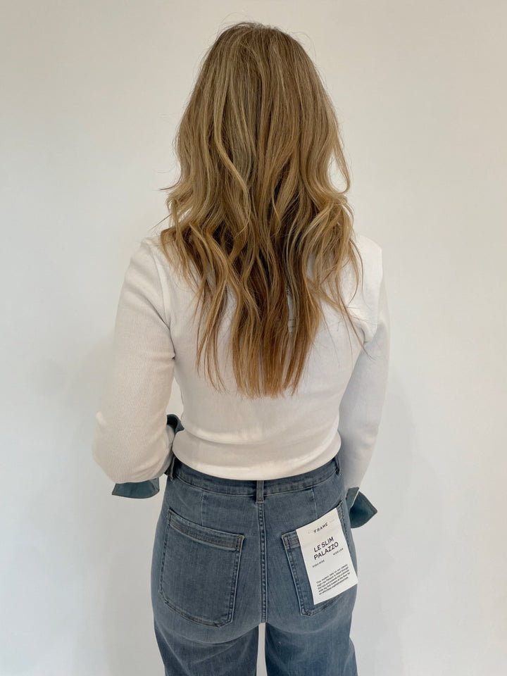 Cinq a Sept Denim Jaden Top in White paired with Frame Le Slim Palazzo Bardot Pocket Jeans in Wilson Clean available at Barbara Katz