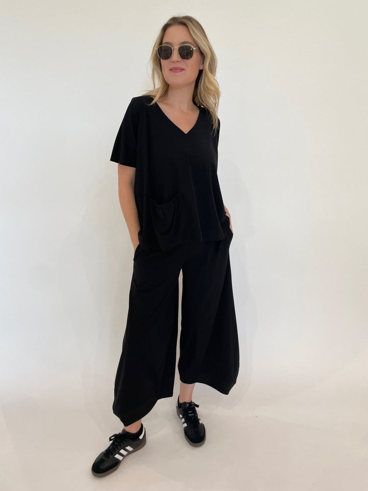 Ozai N Ku Ava V-Neck Pocket Top in Black paired with matching Ozai N Ku Lana Lantern Pants in Black available at Barbara Katz