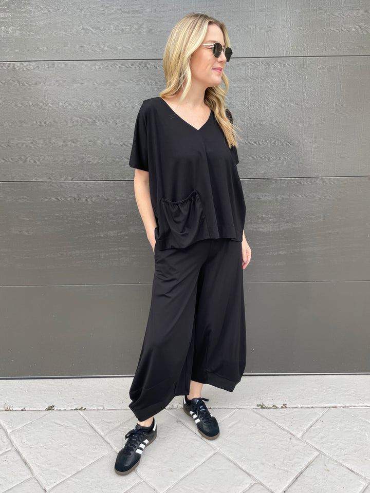 Ozai N Ku Ava V-Neck Pocket Top in Black paired with matching Ozai N Ku Lana Lantern Pants in Black available at Barbara Katz