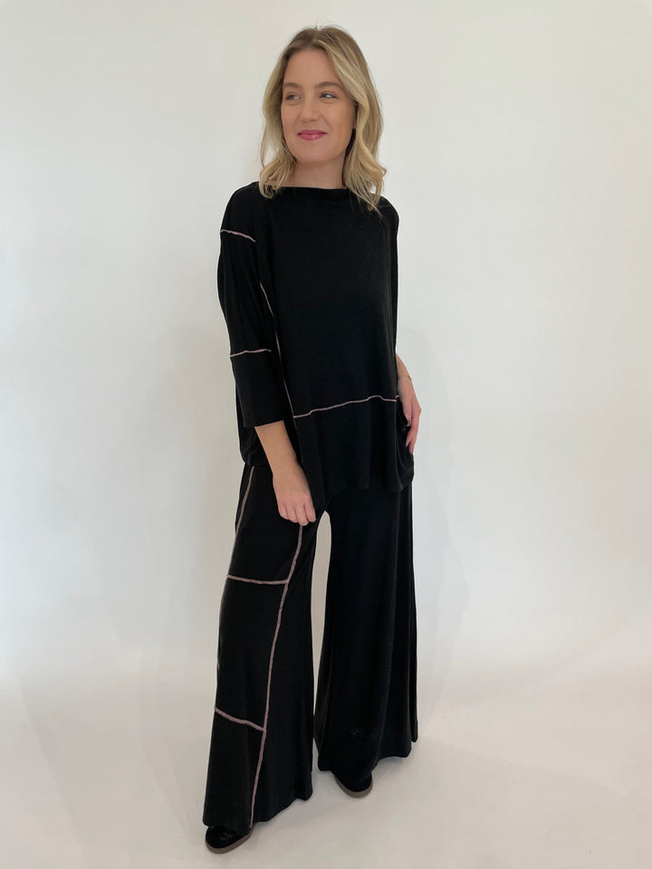 Ozai N Ku Lira 3/4 Sleeve Contrast Stitch Top in Black/Pink paired with matching Kira Wide Leg Contrast Stitch Pants available at Barbara Katz