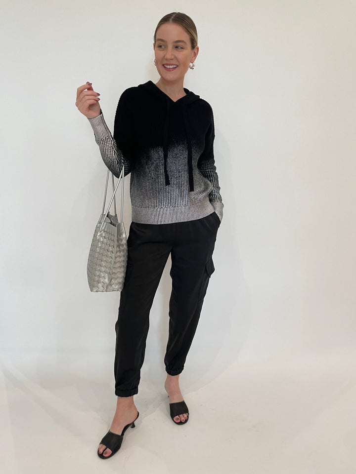 J Society Metallic Ombre Shaker Hoodie in Black paired with J Society Satin Cargo Pants in Black, Lizzie Fortunato Onda Hoops in Silver, BK Victoria Medium Tote Bag in Silver available at Barbara Katz