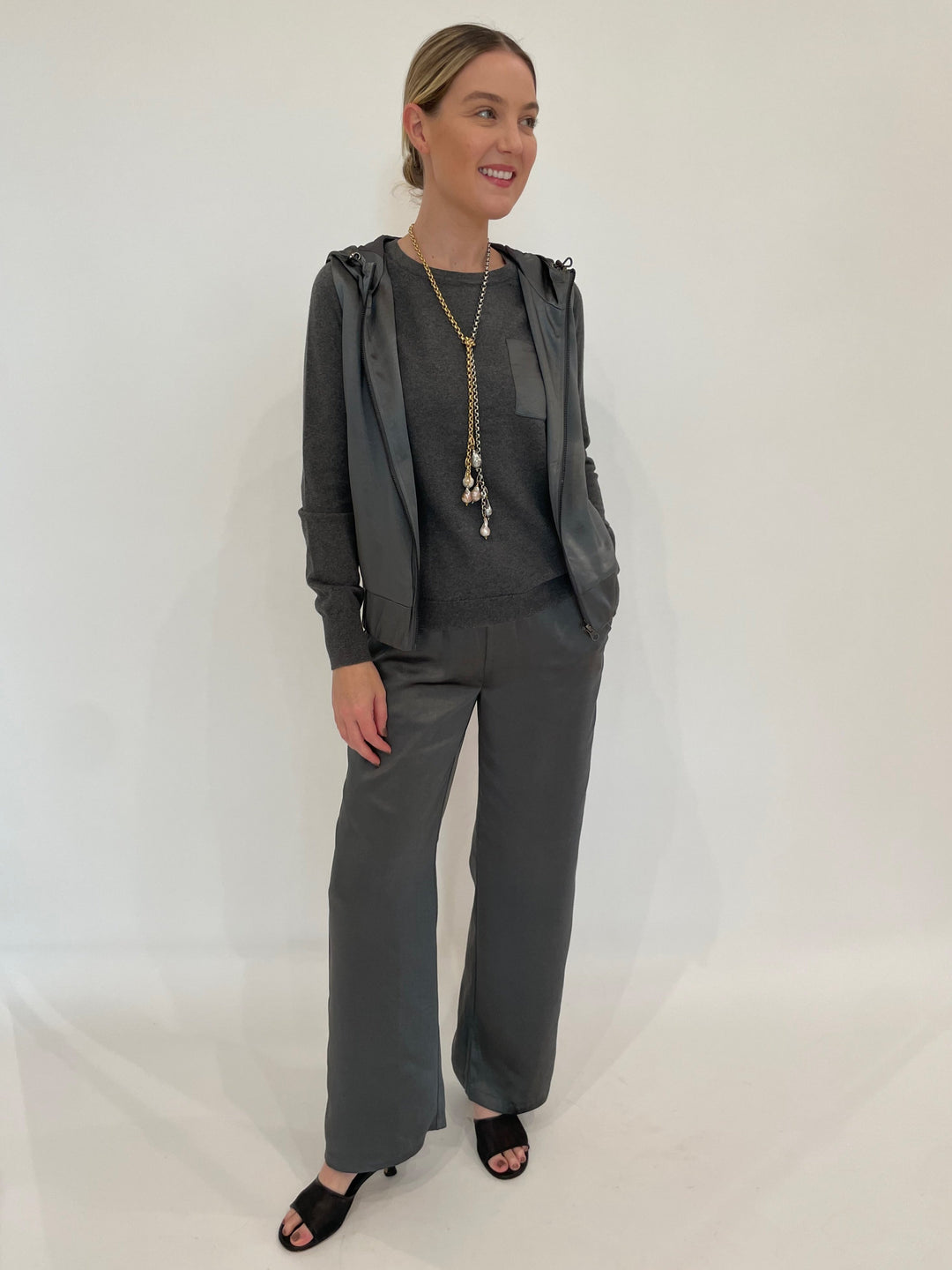 J Society Satin Pocket Sweatshirt and Satin Hoodie Vest in Gunmetal paired with matching Satin Pants, Suzy T Designs Pearl Lariat Necklace in Gold/Silver available at Barbara Katz