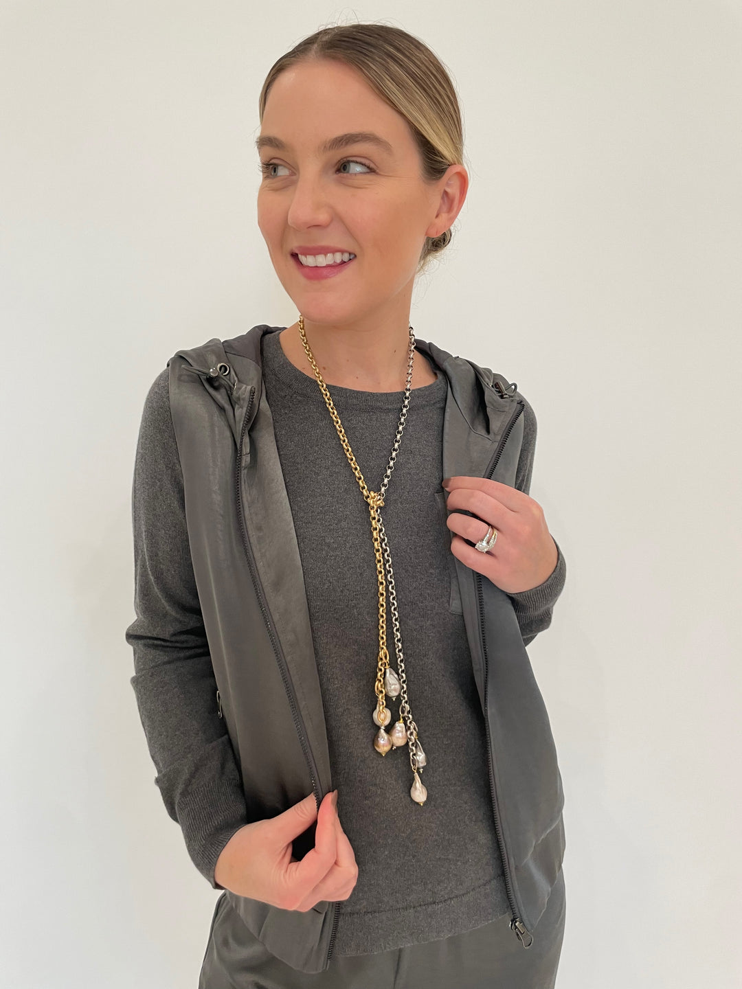 J Society Celeste Satin Hoodie Vest in Gunmetal with Jette Satin Pocket Sweatshirt underneath, Suzy T Pearl Lariat Necklace in Gold/Silver available at Barbara Katz