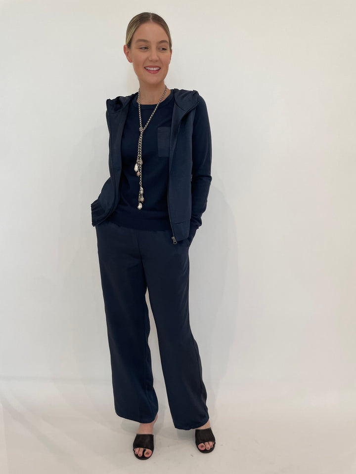 J Society Celeste Satin Hoodie Vest in Navy with Jette Satin Pocket Sweatshirt underneath, paired with matching J Society Jesse Satin Pants in Navy, Suzy T Pearl Lariat Necklace in Antique Silver available at Barbara Katz