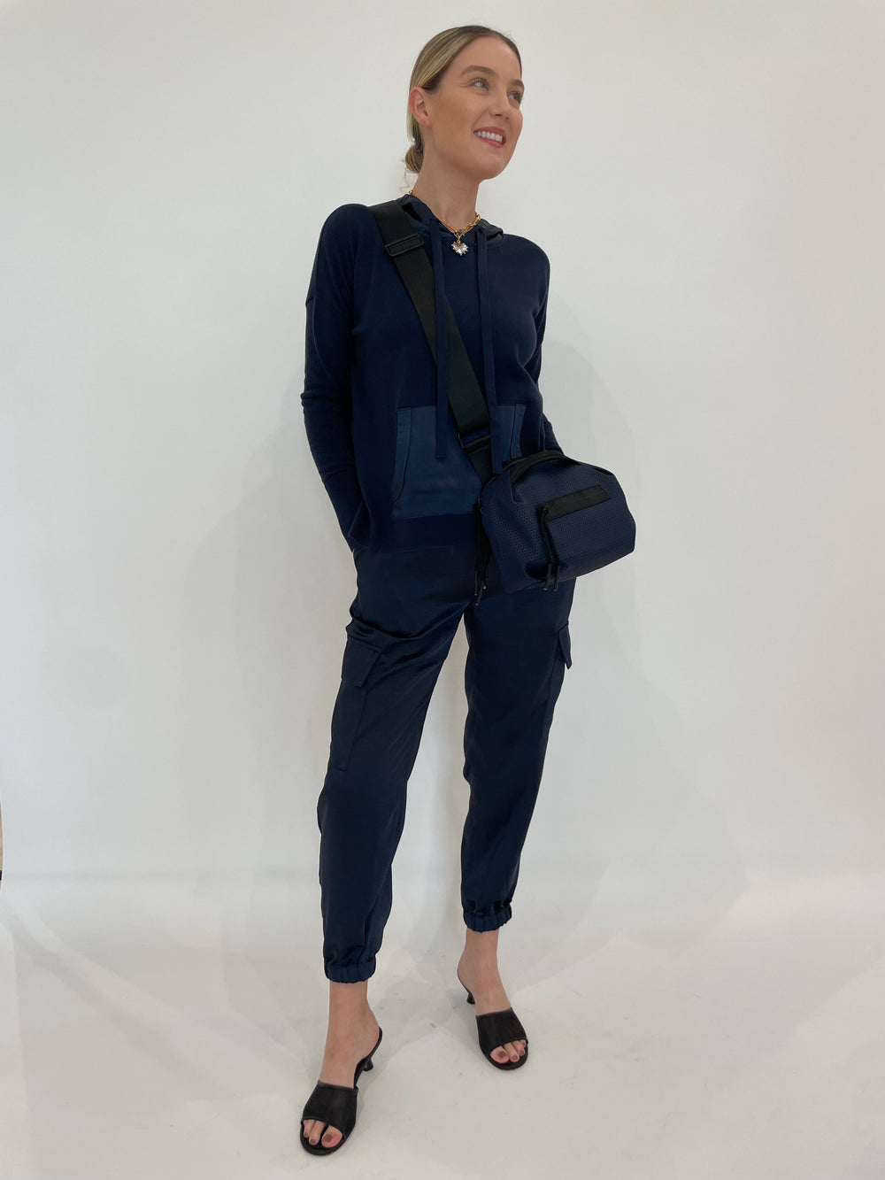 J Society Juno Satin Cargo Pants in Navy paired with matching J Society Roxie Satin Pocket Hoodie in Navy, Elizabeth Cole Jewelry Meira Necklace, Daniella Lehavi Bonnie Crossbody Bag in Navy available at Barbara Katz