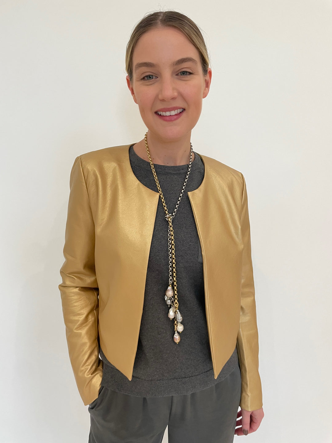 J Society Gold Metallic Collarless Jacket with J Society Gunmetal Satin Pocket Sweatshirt underneath, paired with J Society Gunmetal Satin Pants, Suzy T Pearl Lariat Necklace in Gold/Silver available at Barbara Katz