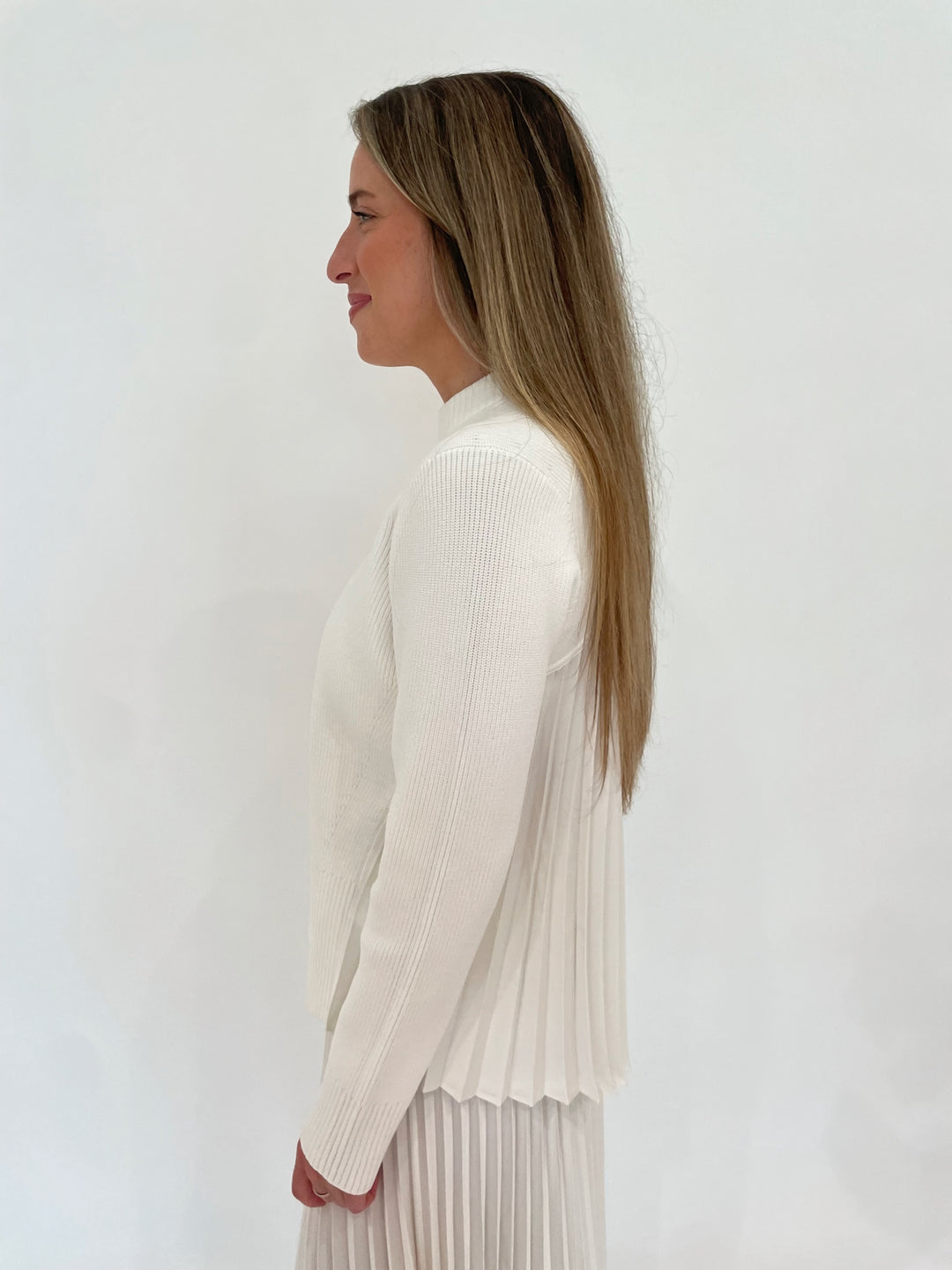 Simkhai Maeve Long Sleeve Pullover Top in Ivory paired with Simkhai Valor Pleated Midi Skirt available at Barbara Katz