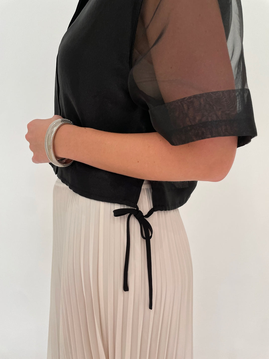 Simkhai Ryett Short Sleeve Crop Shirt in Black paired with Simkhai Valor Midi Skirt in Ivory, BK Silver Cobra Bracelet and July Hammered Wavy Metal Hoop Earrings in Worn Silver - all available at Barbara Katz