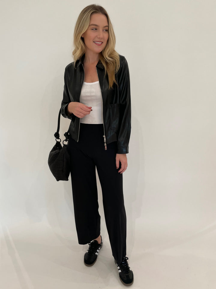 Melisssa Nepton Dona Faux Leather Bomber Jacket in Black with Goldie White Pointelle Cami underneath, paired with Raffaello Rossi Sally 7/8 High Tech Jersey Pants in Black, Daniella Lehavi Dallas Shoulder Bag in Wavy Black - all available a Barbara Katz