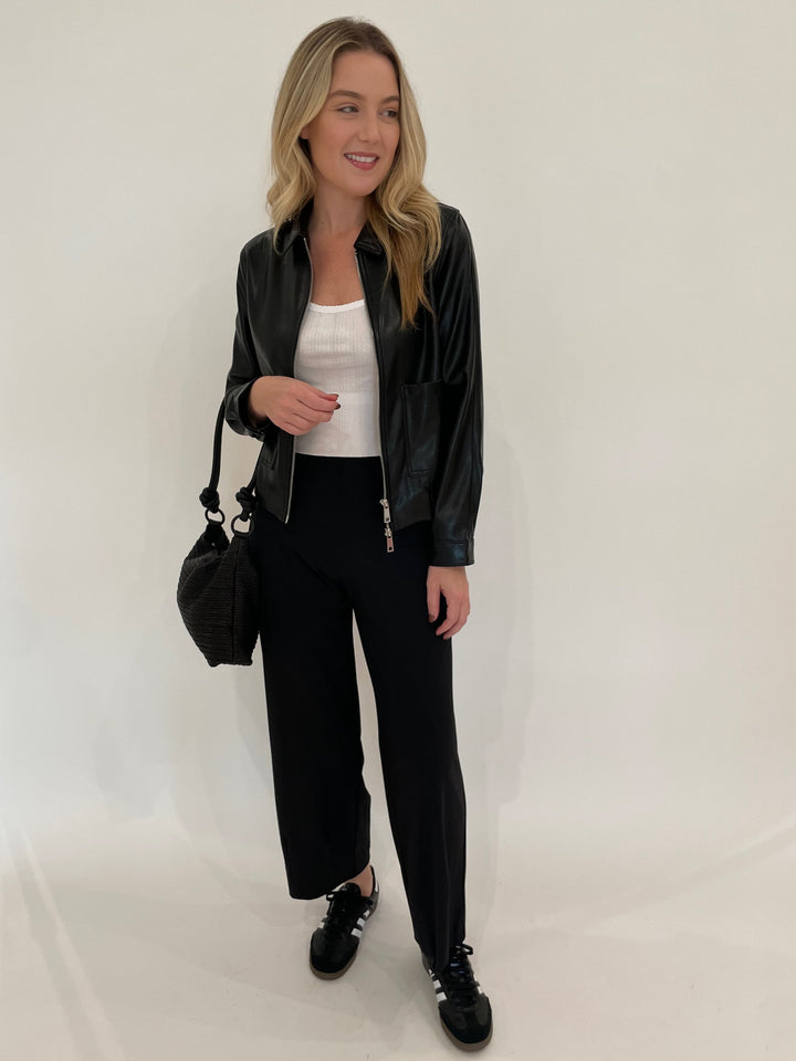 Melisssa Nepton Dona Faux Leather Bomber Jacket in Black with Goldie White Pointelle Cami underneath, paired with Raffaello Rossi Sally 7/8 High Tech Jersey Pants in Black, Daniella Lehavi Dallas Shoulder Bag in Wavy Black - all available a Barbara Katz