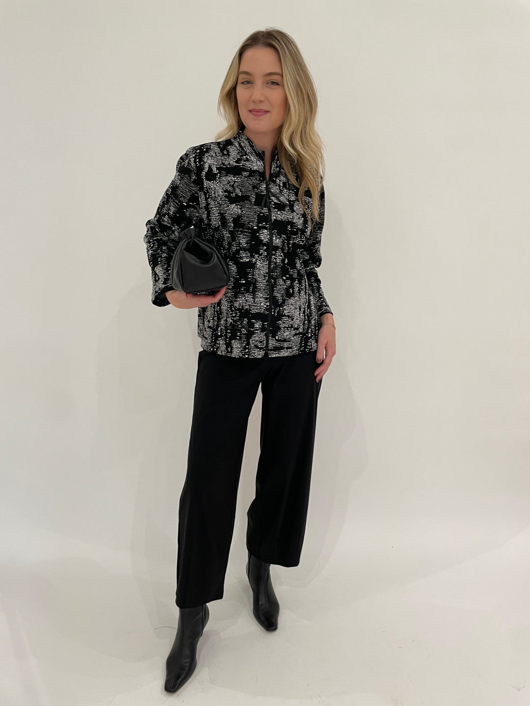 Caroline Rose Melange Knit Zip Jacket in Grey/White/Black paired with Raffaello Rossi Sally 7/8 Pants in Black, DeMellier Miami Clutch in Black - all available at Barbara Katz