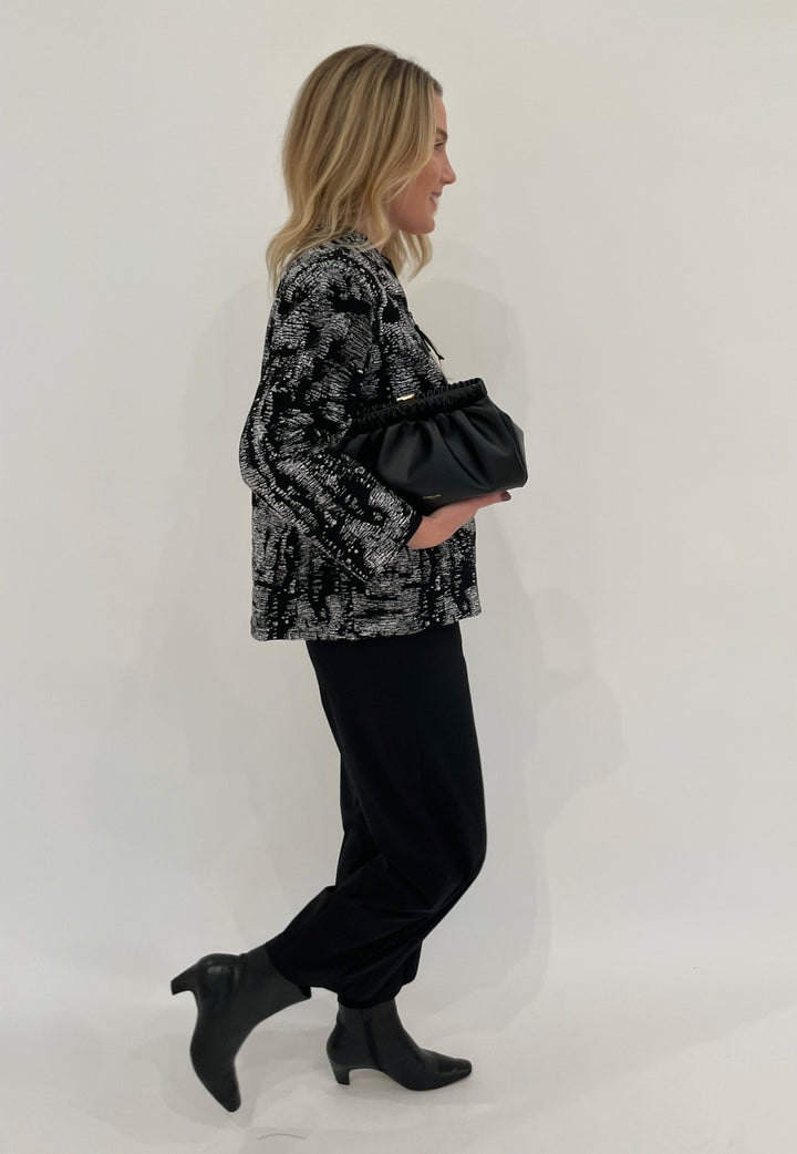 Caroline Rose Melange Knit Zip Jacket in Grey/White/Black paired with Raffaello Rossi Sally 7/8 Pants in Black, DeMellier Miami Clutch in Black - all available at Barbara Katz