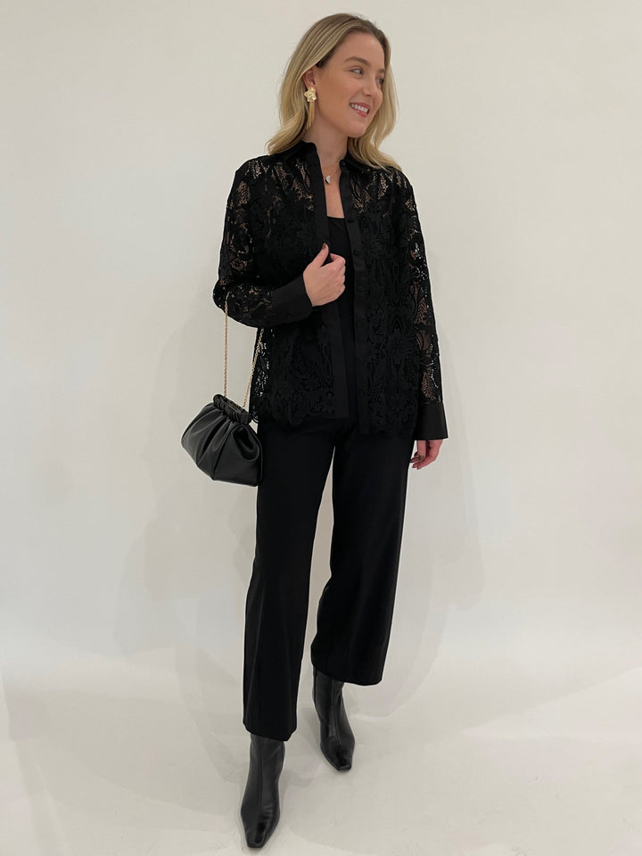 Hinson Wu Margot Long Sleeve Lace Shirt Jacket in Black paired with Raffaello Rossi 7/8 Pants in Black, BK Melanie Gold Hammered Organic & Fringe Earrings, DeMellier Miami Clutch in Black - all available at Barbara Katz