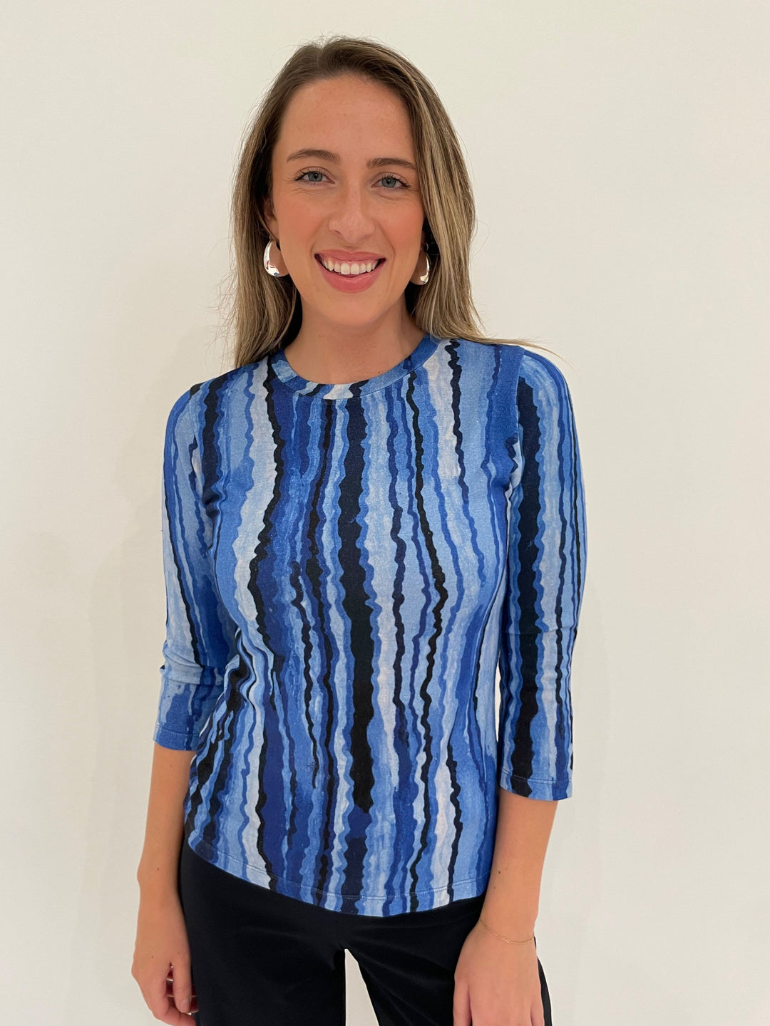 Pashma Contoured Bamboo Silk Lines T-Shirt in Blue paired with Raffaello Rossi 7/8 Sally Pants in Marine, BK Bianca Puffy Triangle Open Hoop Earrings in Silver - all available at Barbara Katz