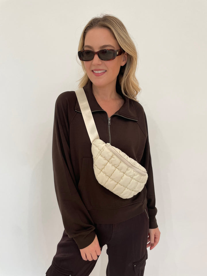 BK Caroline Half Zip-Up Collar Sweatshirt in Chocolate Brown with Le Specs Unreal! Sunglasses in Toffee Tort, Sol and Selene Resurgence Puffer Belt Bag in Ivory available at Barbara Katz