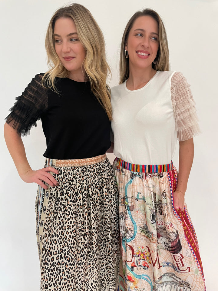 Leo & Ugo Black Knit Short Sleeve Tee paired with ME369 Hayley Sand Viscose Blend Midi Skirt, Leo & Ugo Off White Knit Short Sleeve Tee paired with ME369 Vanessa Rouge Printed Midi Skirt- all available at Barbara Katz