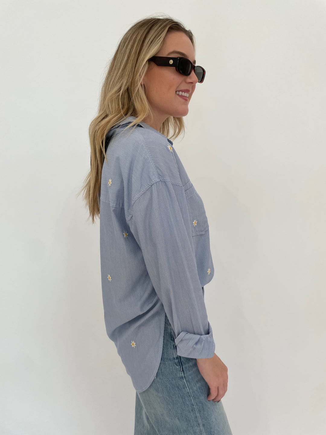 BK Fresh Flower Long Sleeve Shirt in Blue Stripe paired with Pistola Ryder High Rise Cuffed Jeans in Essex, Le Specs Unreal! Sunglasses in Toffee Tort available at Barbara Katz