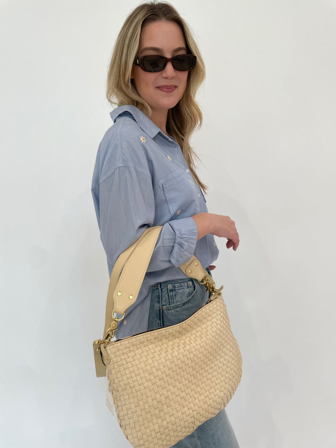 BK Fresh Flower Shirt in Blue Stripe paired with Pistola Ryder High Rise Cuffed Jeans in Essex, Le Specs Unreal! Sunglasses in Toffee Tort, Clare V Moyen Messenger Bag in Cream Woven Checker available at Barbara Katz