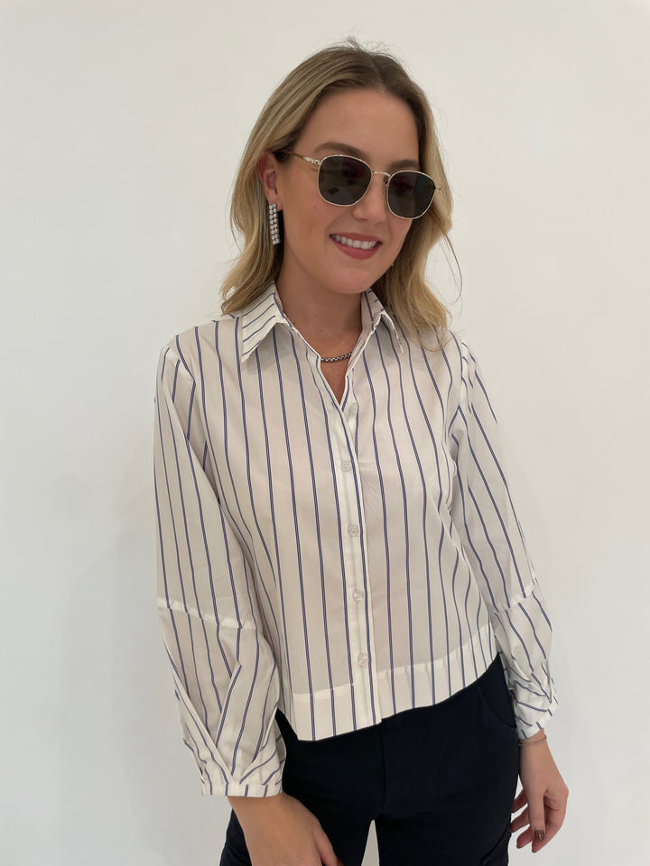 Finley Emmy Double Pinstripe Top in White/Blue paired with Marrakech Gavyn Cargo Pants in Black, Dean Davidson Silver Tokyo Chain Necklace and  Mirabeau Pave Statement Drop Earrings in White Topaz/Silver, Le Specs Neptune Deux Sunglasses - all available at Barbara Katz