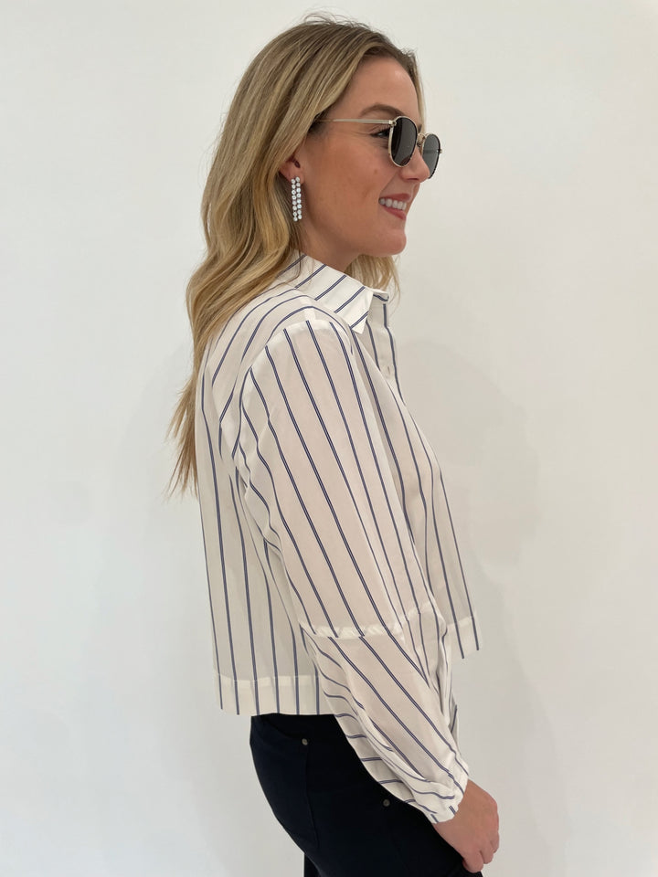 Finley Emmy Double Pinstripe Top in White/Blue paired with Marrakech Gavyn Cargo Pants in Black, Dean Davidson Mirabeau Pave Statement Drop Earrings in White Topaz/Silver, Le Specs Neptune Deux Sunglasses - all available at Barbara Katz