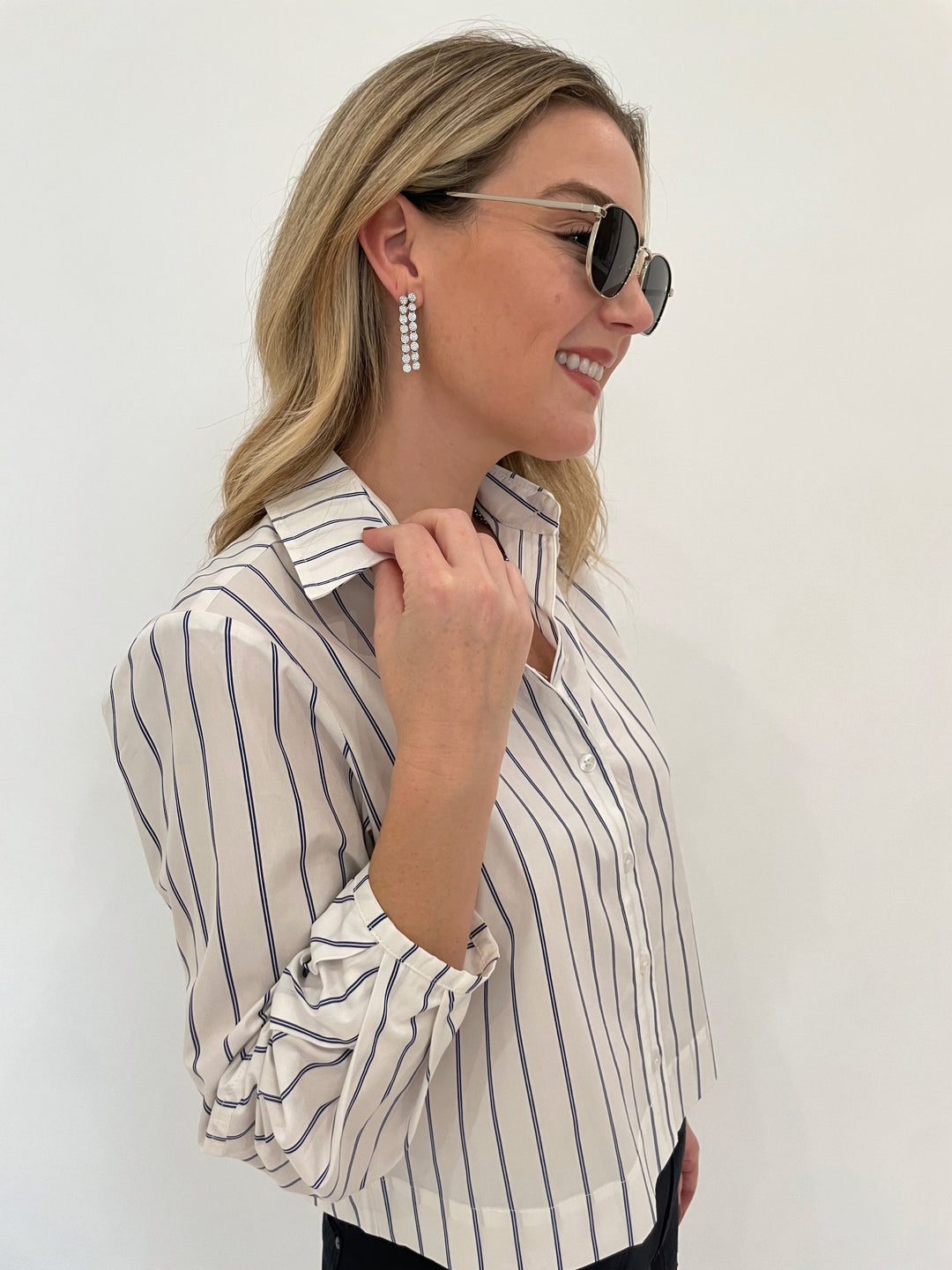 Finley Emmy Double Pinstripe Top in White/Blue, Dean Davidson Mirabeau Pave Statement Drop Earrings in White Topaz/Silver, Le Specs Neptune Deux Sunglasses - all available at Barbara Katz