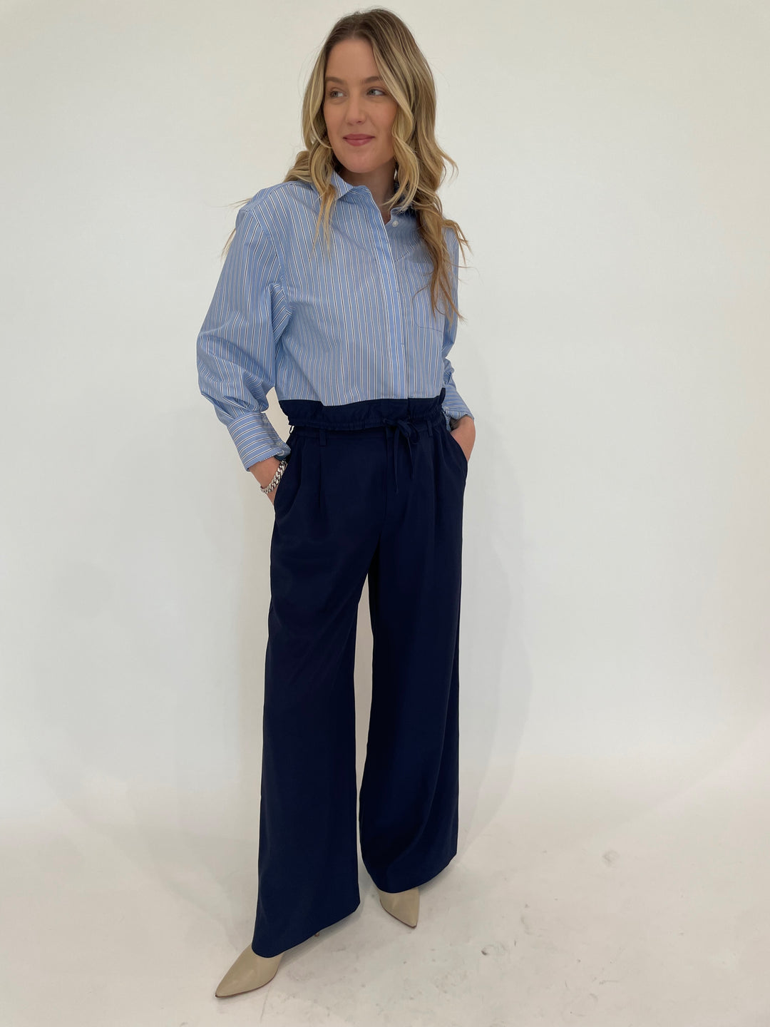 Simkhai Adryck Long Sleeve Shirt in Harbor Blue Stripe paired with SImkhai Sydnie Pleated Pants in Midnight, BK Sheila Links Bracelet With CZ in Silver available at Barbara Katz