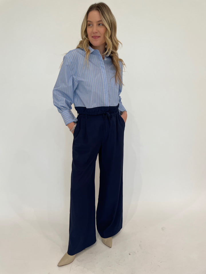 Simkhai Adryck Long Sleeve Shirt in Harbor Blue Stripe paired with SImkhai Sydnie Pleated Pants in Midnight, BK Sheila Links Bracelet With CZ in Silver available at Barbara Katz