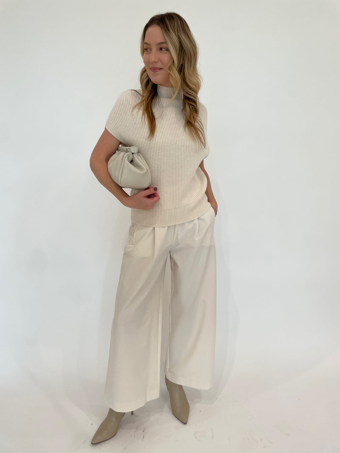 Lilla P. Ribbed Funnel Neck Short Sleeve Sweater in Ivory paired with Lilla P. Wide Leg Pull-On Pants in Winter White, DeMellier Miami Clutch in Off White available at Barbara Katz