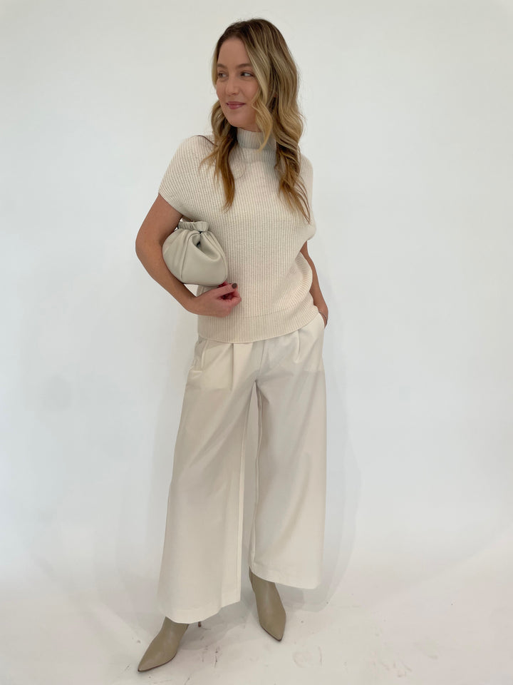 Lilla P. Ribbed Funnel Neck Short Sleeve Sweater in Ivory paired with Lilla P. Wide Leg Pull-On Pants in Winter White, Alexis BIttar Solanales Crystal Large Link Earrings in Gold,  DeMellier Miami Clutch in Off White available at Barbara Katz