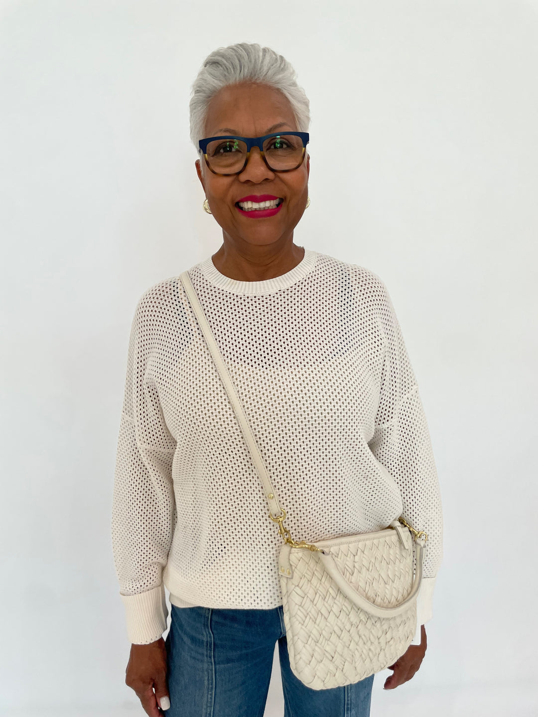 Edinburgh Knitwear Textured Crew Sweater in White paired with Pistola Jadyn Low Slung Palazzo Jeans in Celebration, Clare V Petit Moyen Messenger Bag in Cream Puff Woven - all available at Barbara Katz