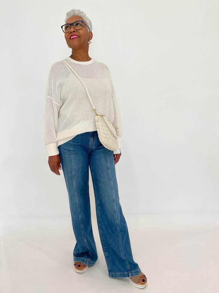 Edinburgh Knitwear Textured Crew Sweater in White paired with Pistola Jadyn Double Button Low Slung Palazzo Jeans in Celebration, Clare V Petit Moyen Messenger Bag in Cream Puff Woven - all available at Barbara Katz