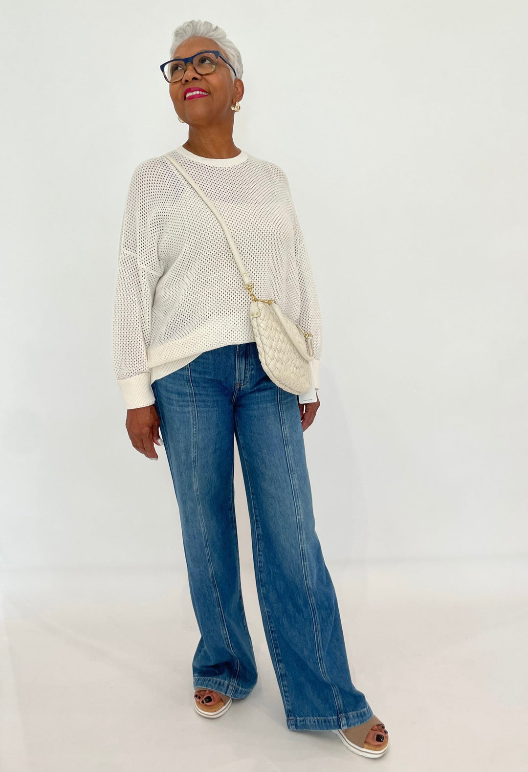 Edinburgh Knitwear Textured Crew Sweater in White paired with Pistola Jadyn Double Button Low Slung Palazzo Jeans in Celebration, Clare V Petit Moyen Messenger Bag in Cream Puff Woven - all available at Barbara Katz