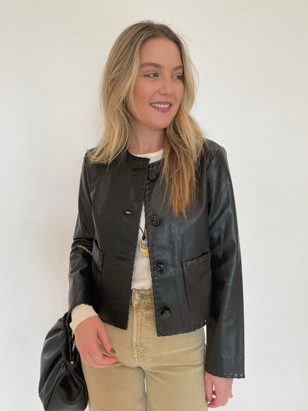 Cinq a Sept Nevina Jacket in Black paired with Citizens of humanity Lyra Crop Wide Leg Jeans in Porcini and DeMellier Miami Clutch in Black available at Barbara Katz