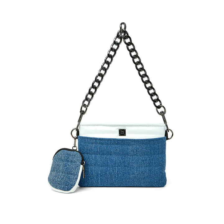 Think Royln Downtown Crossbody Bag in Stone Washed Denim/White with metallic chain handle featuring lightweight quilted polyfill, top zipper closure, front slip pocket, back zip pocket, and clip-on mini bag