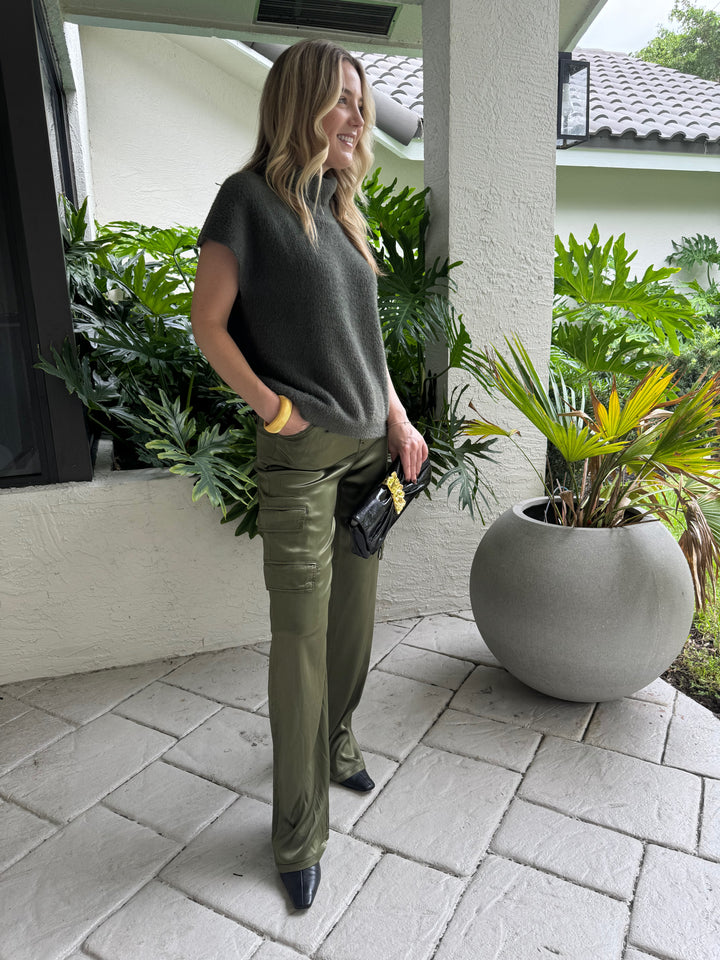 Melissa Nepton Jack Turtleneck Sweater in Winter Moss paired with Marrakech Zendaya Silky Cargo Pants in Pine, BK Gold Cobra Bracelet, and Alexis Bittar Gold Ribbon Convertible Shoulder Bag in Black - all available at Barbara Katz