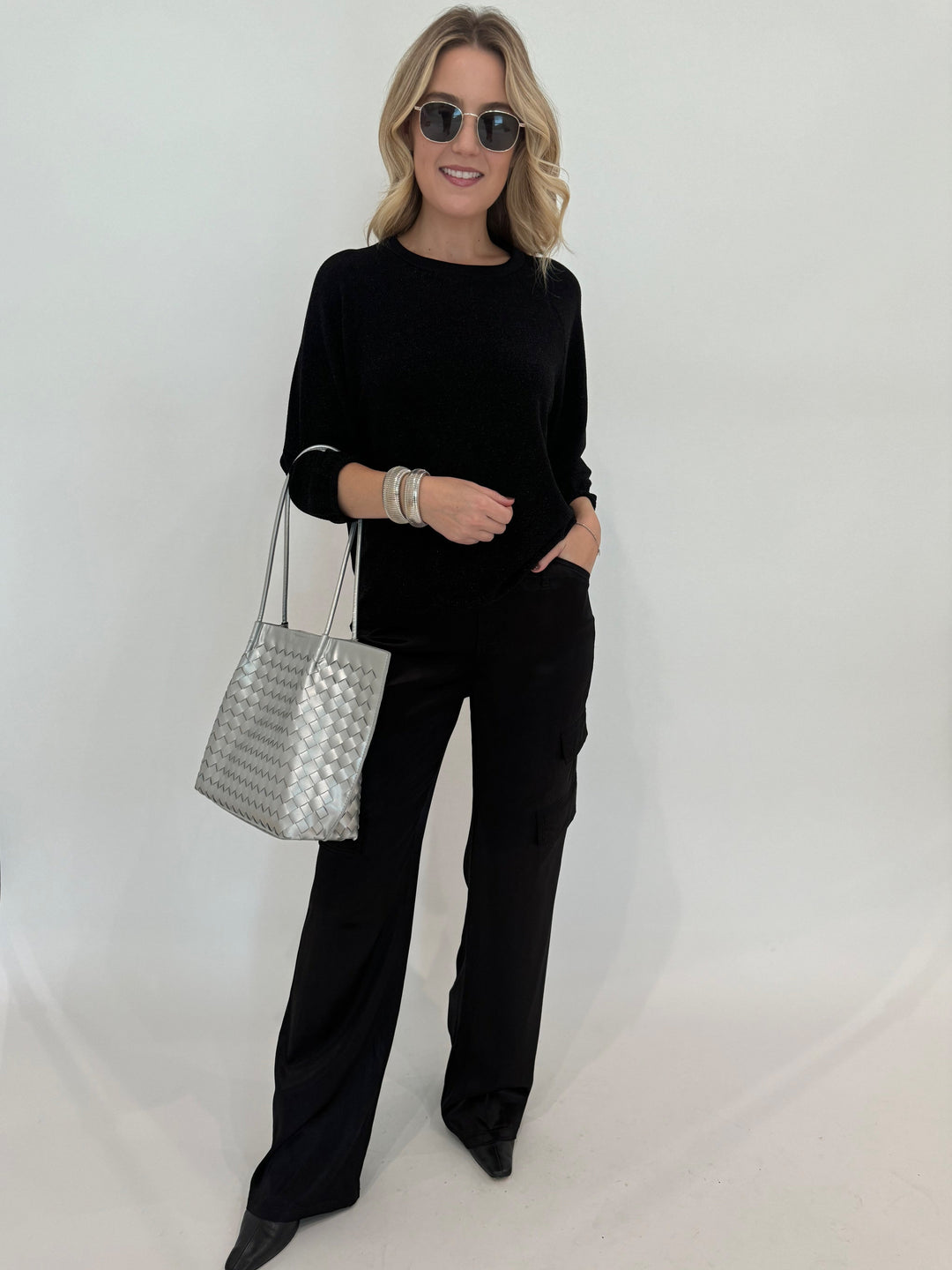 Elliott Lauren Starry Night Raglan Sleeve Top in Black paired with Black Pants, BK Silver Victoria Medium Tote Bag, BK Silver Cobra Cuff and Bracelet, Le Specs Neptune Deux Sunglasses - all available at Barbara Katz