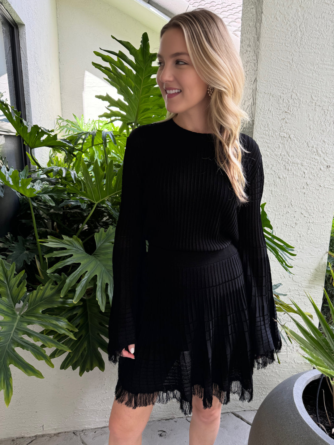 Maria Pavan Miley Fringe Long Sleeve Top in Black paired with Black Fringe Mini Skirt available at Barbara Katz