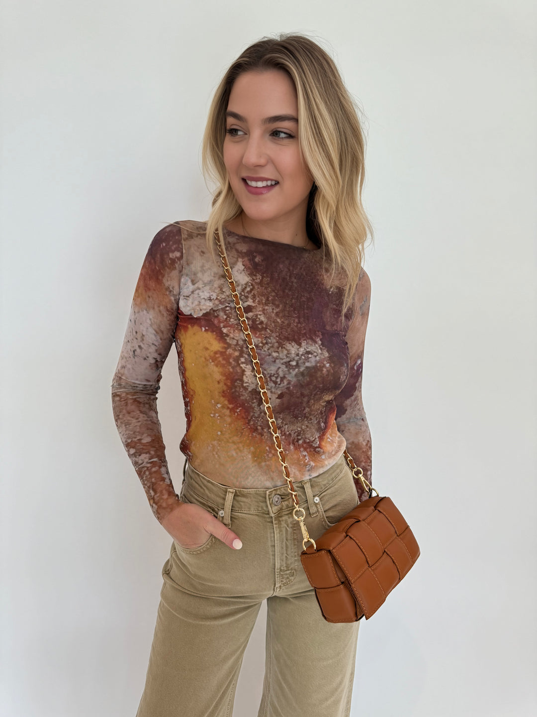 AMB Florence Double Sheer Top in Cavely paired with Citizens of Humanity Lyra Crop Wide Leg Jeans in Porcini, and BK Square Weave Leather Crossbody Bag in Camel, all available at Barbara Katz