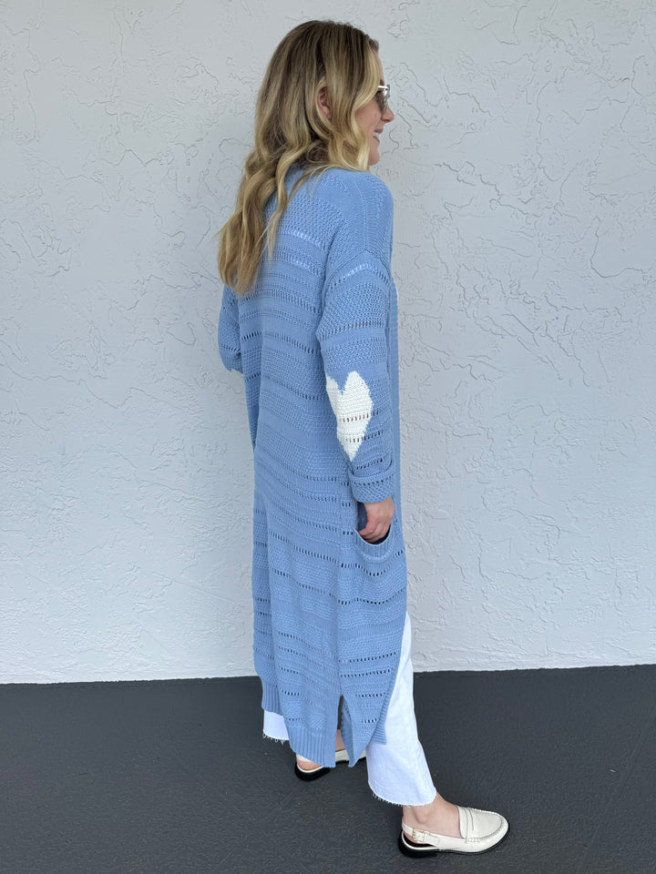 Kerri Rosenthal Sandy Open Stitch Cardigan in Blue, made from 100% cotton featuring a Heart intarsia at elbows, long sleeves with pockets