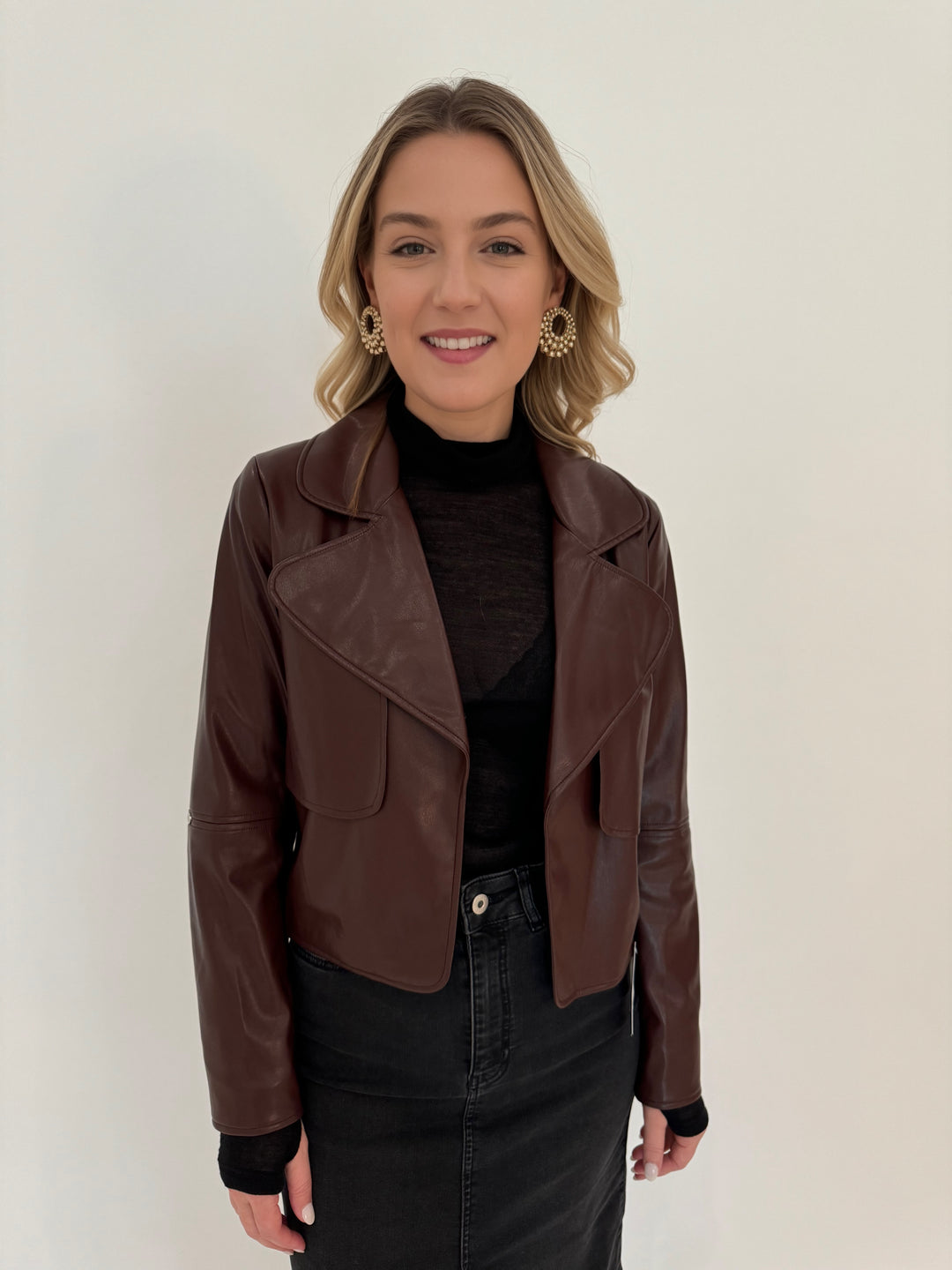 Adroit Atelier Ninon Vegan Leather Open Front Jacket in Chocolate with Aldomartins Black Norin Top underneath, paired with Elliott Lauren Geneva Jean Midi Skirt available at Barbara Katz