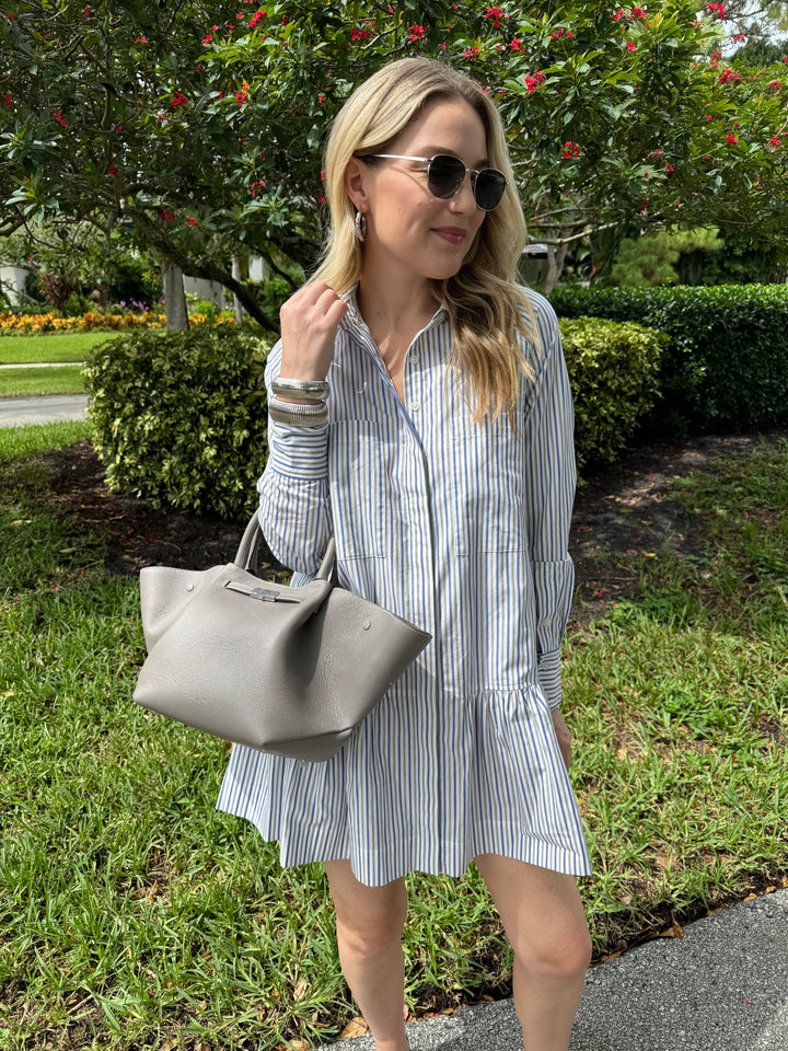 Simkhai Polina Shirt Mini Dress in Cool Gray Stripe with Le Specs Neptune Deux Sunglasses, Alexis Bittar Brut Tube Hoop Earrings in Silver, DeMellier The Midi New York Tote Bag in Stone Grey, BK Silver Cobra Cuff and Bracelet - all available at Barbara Katz