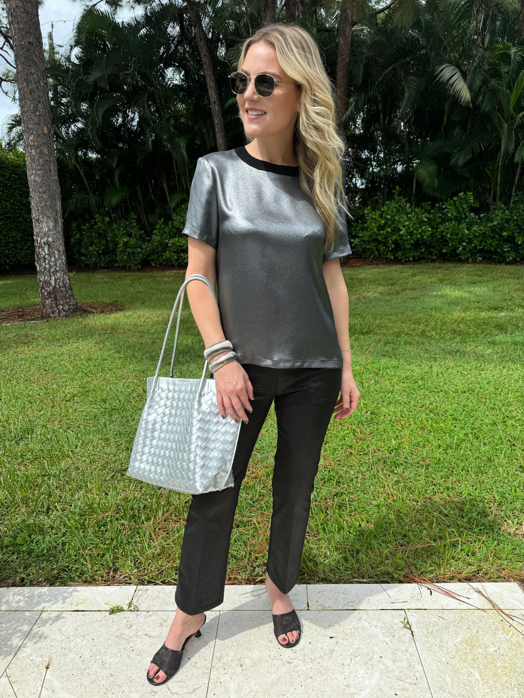 Elliott Lauren Slinky Metallic Tee in Silver paired with Black Lava Pants With Patch Pocket, BK Silver Victoria Medium Tote Bag, BK Silver Cobra Cuff and Bracelet, Le Specs Neptune Deux Sunglasses - all available at Barbara Katz