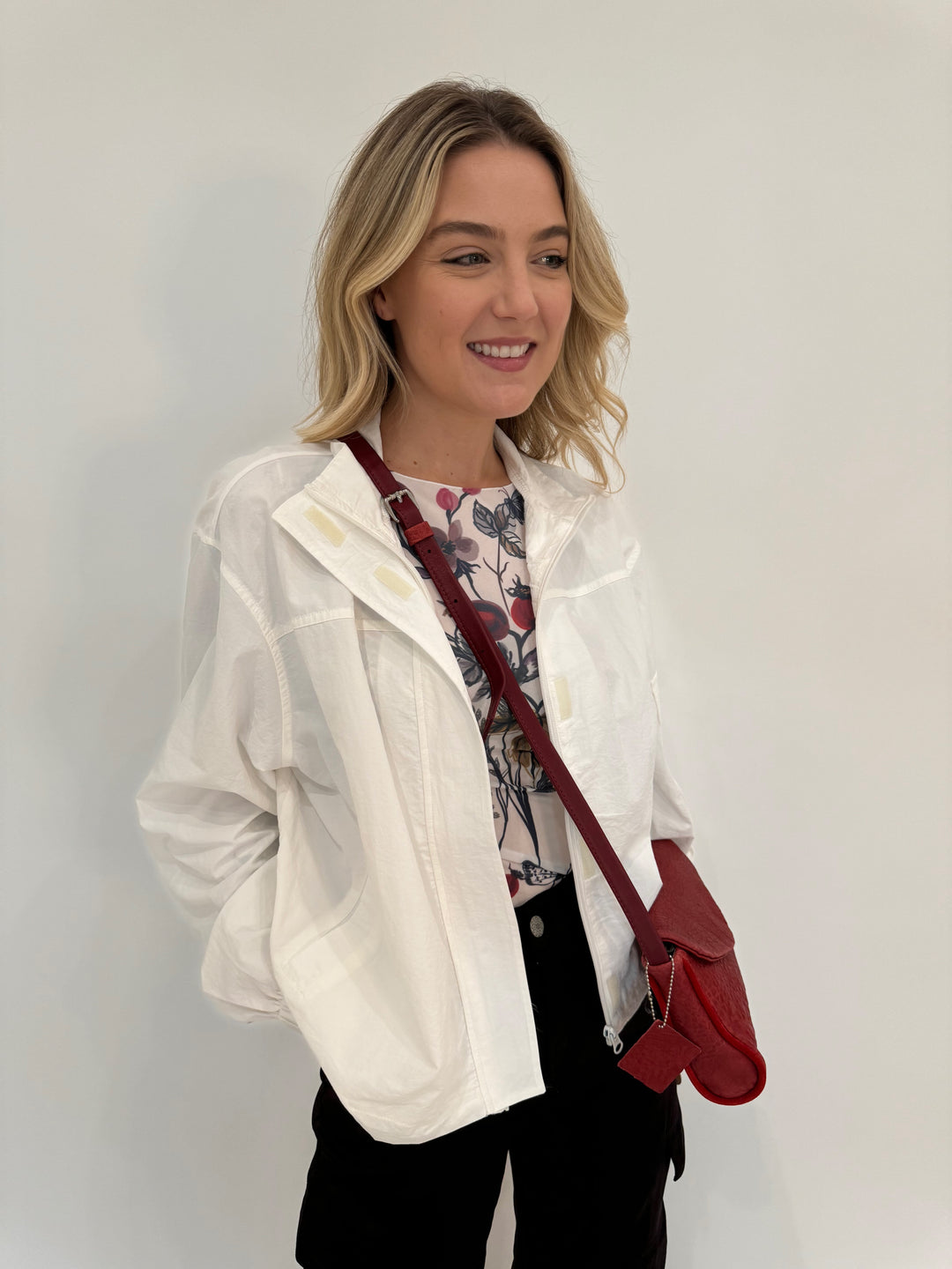 BK Linda Nylon Cropped Windbreaker in Off White with AMB Hello Blossom Second Skin Raw Edge Top underneath, bag Daniella Lehavi Kensington Envelope Crossbody Clutch Bag in Rosso Red - all available at Barbara Katz